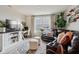 Comfortable living room with a large TV, a white desk and a cozy leather sectional at 6630 Overlander Ln, Whitestown, IN 46075