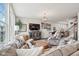 Inviting living room features a sectional sofa, media center, large windows, and stylish decor at 6630 Overlander Ln, Whitestown, IN 46075