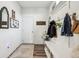 Bright mud room features a bench with storage and decorative hooks for hanging coats and bags at 6630 Overlander Ln, Whitestown, IN 46075