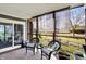 Cozy back porch with wicker furniture and views of the wooded backyard at 6820 W Forest Brook Dr, Fountaintown, IN 46130