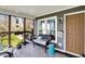 Outdoor porch with wicker furniture, sliding glass doors, and outdoor lighting at 6820 W Forest Brook Dr, Fountaintown, IN 46130