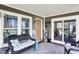 Outdoor porch featuring wicker furniture, an outdoor rug, and a door leading to the yard at 6820 W Forest Brook Dr, Fountaintown, IN 46130