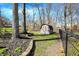 Fenced backyard includes a storage shed and ample space for gardening and recreation at 6820 W Forest Brook Dr, Fountaintown, IN 46130