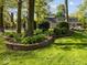 Beautiful backyard with retaining wall flowerbed, trees and landscaping at 6820 W Forest Brook Dr, Fountaintown, IN 46130