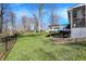 Large backyard with a deck, a fence, and mature trees at 6820 W Forest Brook Dr, Fountaintown, IN 46130
