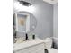 Well-lit bathroom with a round mirror, vanity, modern fixtures, and a clean, neutral color palette at 6820 W Forest Brook Dr, Fountaintown, IN 46130