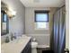 Updated bathroom featuring a modern vanity, elegant fixtures, and a shower with a curtain at 6820 W Forest Brook Dr, Fountaintown, IN 46130