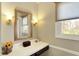 Well-lit bathroom featuring a vanity with a mirror, a window, and elegant decor at 6820 W Forest Brook Dr, Fountaintown, IN 46130