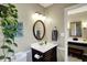 Bathroom featuring a vanity with dark wood cabinets, decorative mirror and good lighting at 6820 W Forest Brook Dr, Fountaintown, IN 46130
