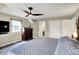 Bright bedroom with hardwood floors, a ceiling fan, natural lighting, and closet space at 6820 W Forest Brook Dr, Fountaintown, IN 46130