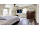 Cozy bedroom with a comfortable bed, dresser, ceiling fan, and natural light from the windows at 6820 W Forest Brook Dr, Fountaintown, IN 46130