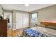 Bedroom with natural light, wood floors, large closet, and a comfy bed at 6820 W Forest Brook Dr, Fountaintown, IN 46130