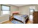 Bedroom features a comfortable bed, wood floors and trim, and a view to a hallway at 6820 W Forest Brook Dr, Fountaintown, IN 46130