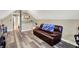 Bonus room with vinyl flooring, leather couch and a Colts throw at 6820 W Forest Brook Dr, Fountaintown, IN 46130