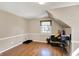 Bonus room with neutral paint and hardwood floors plus plenty of storage shelves at 6820 W Forest Brook Dr, Fountaintown, IN 46130
