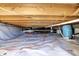 Encapsulated crawl space featuring clean, white vapor barrier and access to plumbing and utilities at 6820 W Forest Brook Dr, Fountaintown, IN 46130