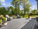 Outdoor deck featuring outdoor seating, composite decking, wood railing, and manicured yard at 6820 W Forest Brook Dr, Fountaintown, IN 46130