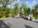 Outdoor deck featuring outdoor seating, composite decking, wood railing, and wooded view at 6820 W Forest Brook Dr, Fountaintown, IN 46130