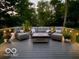 Outdoor deck with comfortable seating and overhead string lights, perfect for evening relaxation at 6820 W Forest Brook Dr, Fountaintown, IN 46130