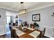 Bright dining room featuring a modern chandelier and views of the formal living room and fireplace at 6820 W Forest Brook Dr, Fountaintown, IN 46130