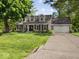 Charming home with gray siding, dormer windows, two-car garage and green lawn in a landscaped setting at 6820 W Forest Brook Dr, Fountaintown, IN 46130