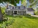 Charming home featuring a manicured lawn, gray siding, dormer windows, and a two-car garage at 6820 W Forest Brook Dr, Fountaintown, IN 46130