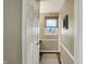 Neutral hallway with hardwood floors, a window for natural light, and classic trim at 6820 W Forest Brook Dr, Fountaintown, IN 46130