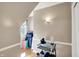 Hallway with hardwood floors and beige walls, leading to a window with natural light at 6820 W Forest Brook Dr, Fountaintown, IN 46130
