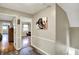 Hallway with vinyl flooring, a dog art piece, and access to the bonus room at 6820 W Forest Brook Dr, Fountaintown, IN 46130