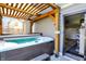 Relaxing hot tub area with wooden pergola, a garage entrance, and 