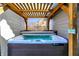 Relaxing hot tub with cover in a backyard setting with wooden pergola at 6820 W Forest Brook Dr, Fountaintown, IN 46130