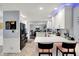 Stylish kitchen featuring white cabinets, stainless steel appliances, a breakfast bar and an adjacent dining area at 6820 W Forest Brook Dr, Fountaintown, IN 46130
