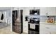 Bright kitchen featuring stainless steel appliances and a view to the living room, perfect for entertaining at 6820 W Forest Brook Dr, Fountaintown, IN 46130