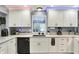 Bright kitchen featuring quartz counters and modern appliances with easy access to the backyard at 6820 W Forest Brook Dr, Fountaintown, IN 46130