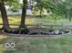 Charming landscaping featuring a decorative wooden bridge, lush plants, and fresh mulch at 6820 W Forest Brook Dr, Fountaintown, IN 46130