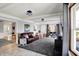 Bright living room with a view of the backyard, comfortable seating, and a modern entertainment setup at 6820 W Forest Brook Dr, Fountaintown, IN 46130