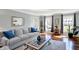 Bright living room with hardwood floors, large windows, a comfortable couch, and neutral tones at 6820 W Forest Brook Dr, Fountaintown, IN 46130
