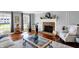 Bright living room featuring a brick fireplace, hardwood floors, and large windows at 6820 W Forest Brook Dr, Fountaintown, IN 46130