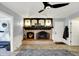 Charming living room with fireplace, modern ceiling fan, and a cozy atmosphere for relaxing at 6820 W Forest Brook Dr, Fountaintown, IN 46130