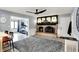 Cozy living room with fireplace, modern ceiling fan, gray rug, and an open layout at 6820 W Forest Brook Dr, Fountaintown, IN 46130