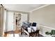 Home office featuring wood floors, a modern desk setup, and ample natural light with wainscotting at 6820 W Forest Brook Dr, Fountaintown, IN 46130