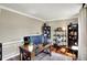 Bright home office features a wooden desk, shelving, and hardwood floors for a professional space at 6820 W Forest Brook Dr, Fountaintown, IN 46130