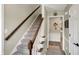 Carpeted staircase featuring wood handrail and white risers leading to the upper level at 6820 W Forest Brook Dr, Fountaintown, IN 46130