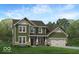 Charming two-story home features a brick-accented facade, attached two-car garage, and a welcoming front porch at 6869 W Buck Stone Dr, McCordsville, IN 46055