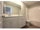Bathroom featuring double vanity with large mirror, and a tub with shower head at 735 Locust Dr, Danville, IN 46122