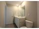 Bathroom with a double sink vanity, a large mirror, and a white toilet at 735 Locust Dr, Danville, IN 46122