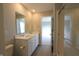 Bright bathroom features a double sink vanity, a large mirror, and a glass-enclosed shower at 735 Locust Dr, Danville, IN 46122