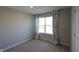 This bedroom has neutral carpet and walls with a window with stylish floral curtains at 735 Locust Dr, Danville, IN 46122