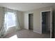 Well-lit bedroom features a closet and window with stylish blue and white floral curtains at 735 Locust Dr, Danville, IN 46122
