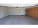 Spacious garage with concrete flooring, interior door, and partially finished walls at 735 Locust Dr, Danville, IN 46122